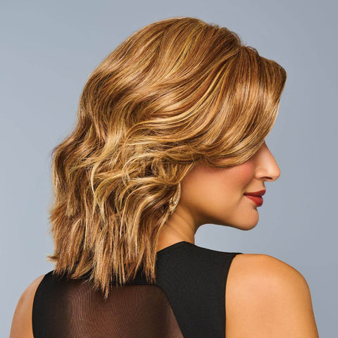 Side-view of Steal The Show, a short wavy golden-blonde wig with layered curls