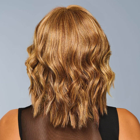 Back view of Steal The Show, a short wavy golden-blonde wig with layered curls